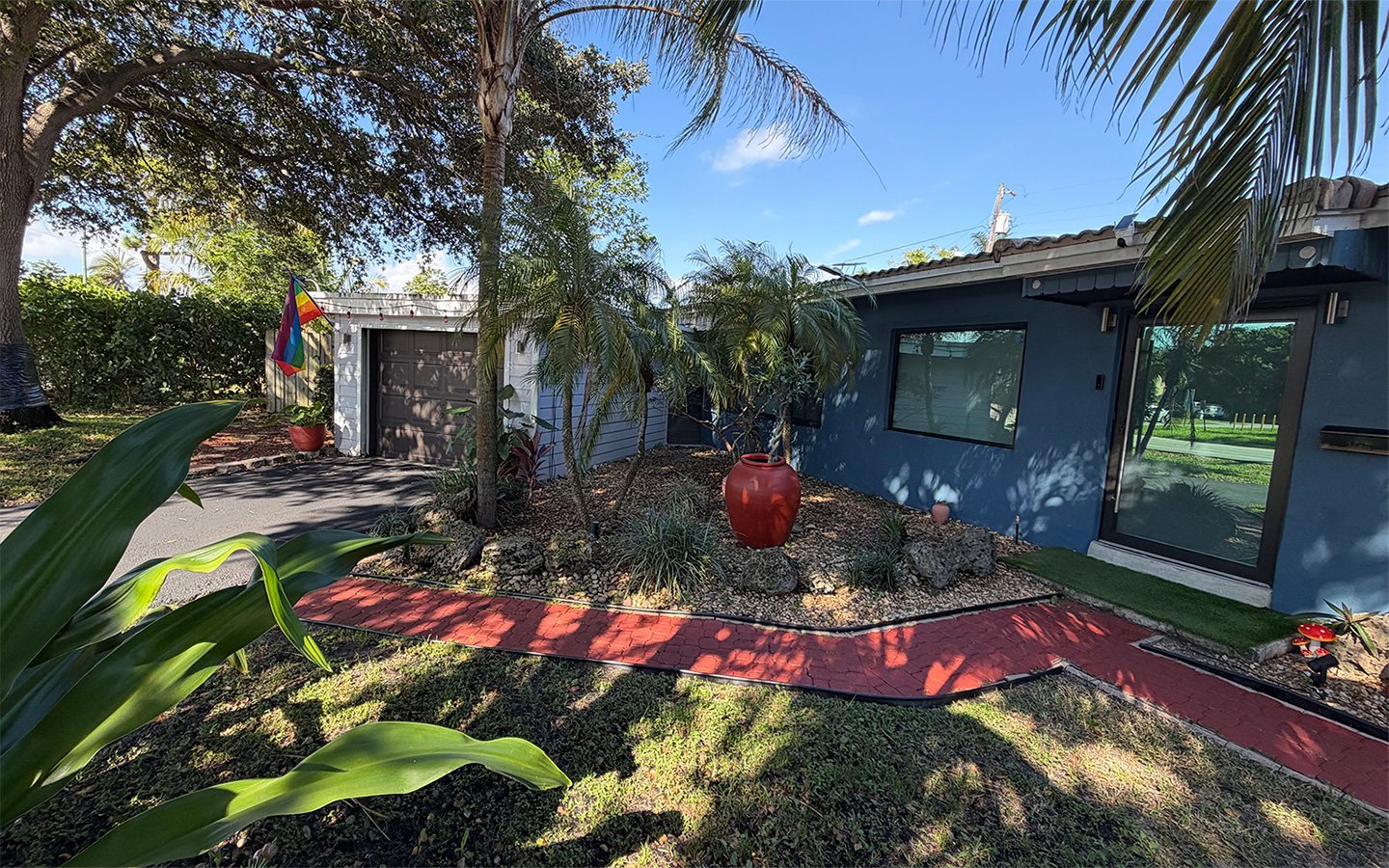 Outdoor garden area at Garden of Manors, featuring tropical landscaping and thoughtfully designed common spaces.