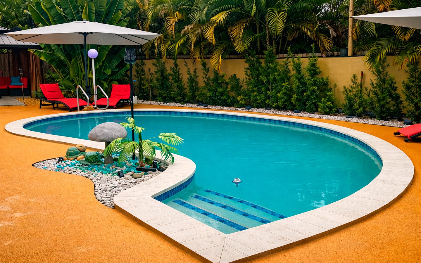 Heated, clothing-optional pool surrounded by lush tropical landscaping.