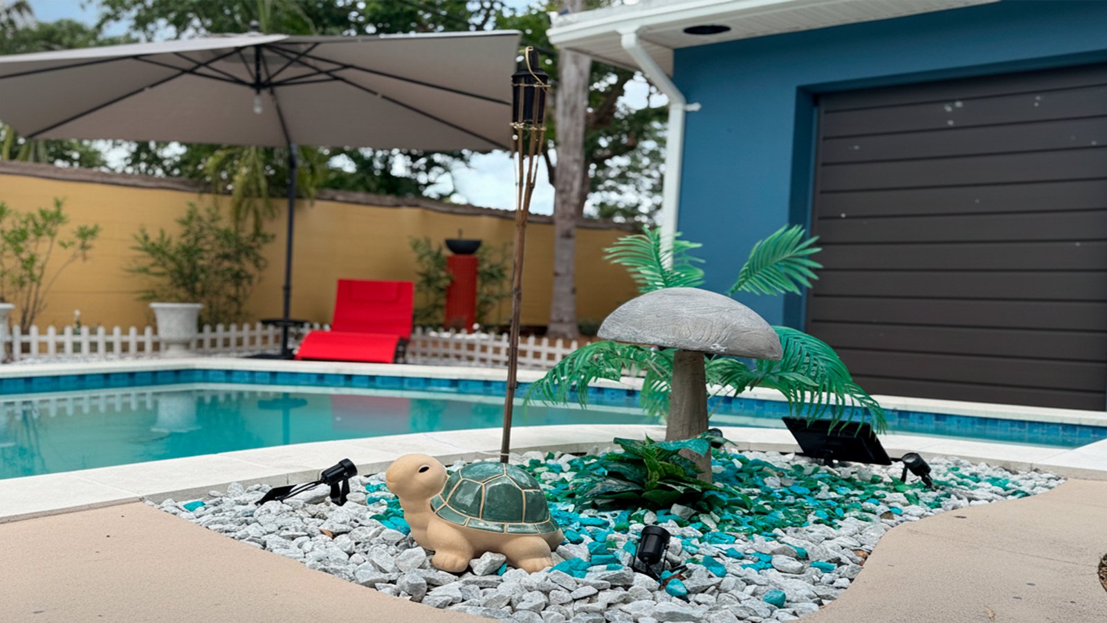 Dayttime pool at Garden of Manors, featuring tropical surroundings, and a relaxed evening atmosphere.