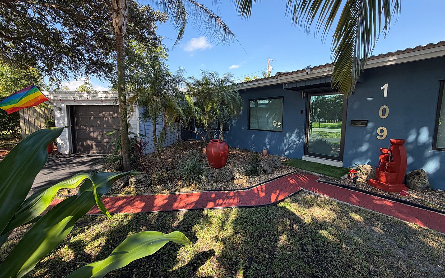 Outdoor garden area at Garden of Manors, featuring tropical landscaping and thoughtfully designed common spaces.