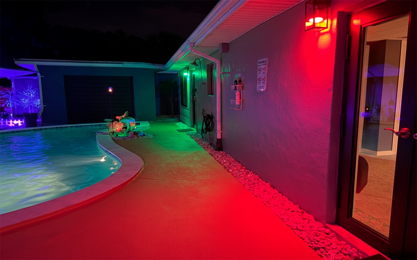 Evening poolside setting at Garden of Manors near The Red Room, enhanced by ambient lighting and tropical surroundings.