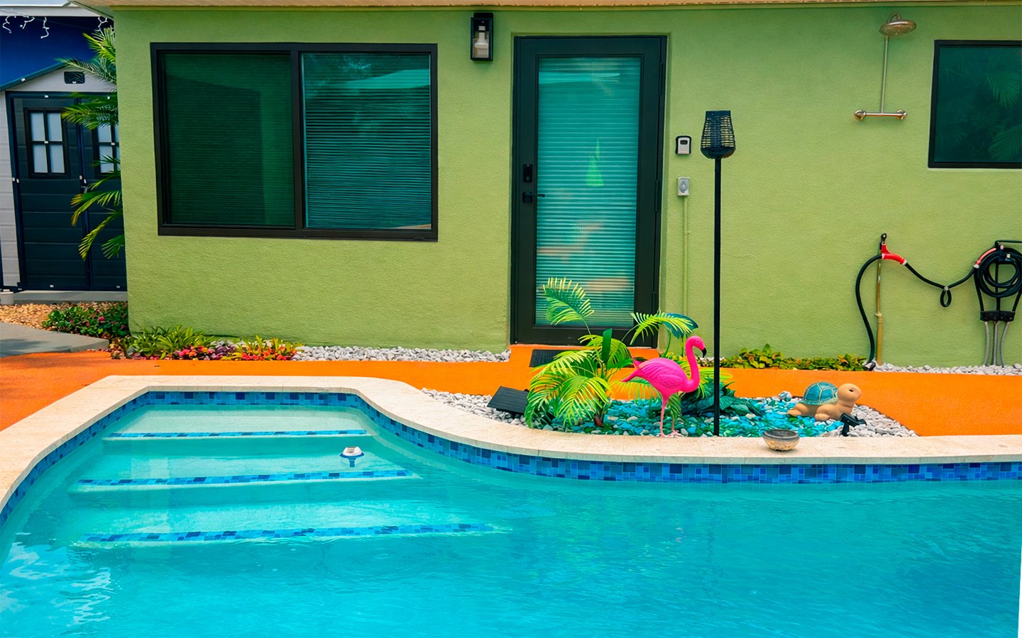 Day exterior view of The Green Room at Garden of Manors, featuring poolside surroundings.